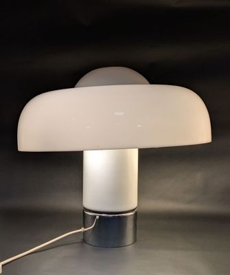 a close up of a lamp on a table with a black background