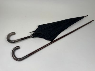 a black umbrella that is sitting on a white table