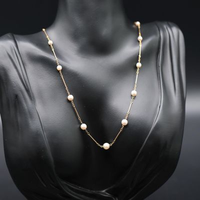 a gold and pearl necklace on a mannequin mannequin mannequin mannequin mannequin mannequin mannequin mannequin mann