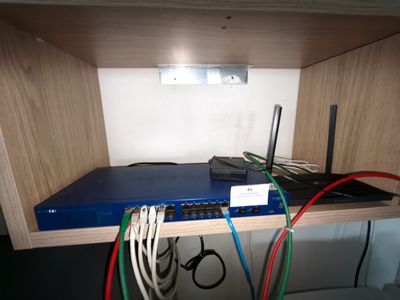 a blue box with wires and a laptop on top of it