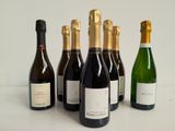 six bottles of wine are lined up in a row on a table