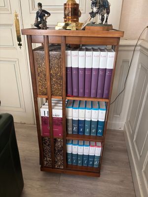 a book shelf with a lot of books on top of it