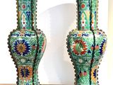 two vases that are sitting on top of a dresser