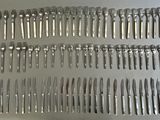 many forks and spoons that are on the table