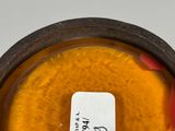 a close up of a vase with a label on it