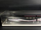 a close up of a pen in a clear case on a black surface