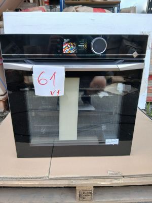 a black and white oven sitting on top of a cardboard box