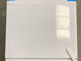 a white refrigerator with a blue tape on it