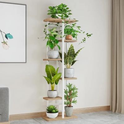 a plant stand in the corner of a living room