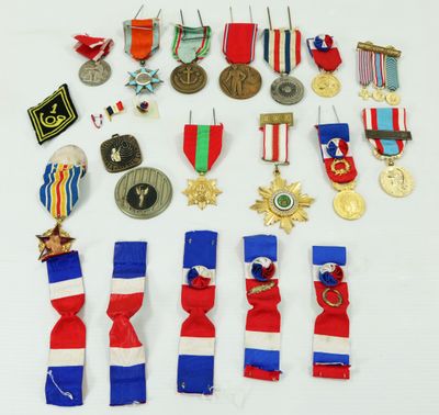 an assortment of medals and medals are displayed on a white surface