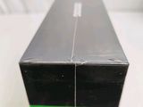 a black box with a green lid sitting on a table
