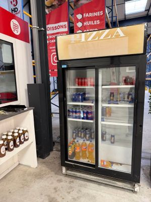 a display case with drinks in it in a store
