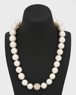 a white pearl and diamond necklace on a mannequin