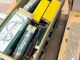 many boxes of pens and pencils sitting on a table