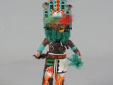 figurine of a native american man with a feathered headdress