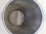 an overhead view of a metal mixing bowl on a concrete floor