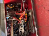 a red box with tools in it sitting on the floor