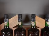 three bottles of wine sit in a wooden crate on a table