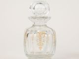 clear glass perfume bottle with gold trim on a white background