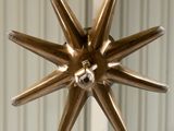 an image of a metal starburst hanging from a ceiling