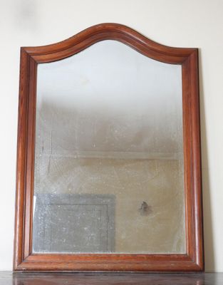 a mirror sitting on top of a dresser in a room