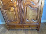 a wooden armoire with two doors on it