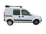 the white van is parked on the side of the road