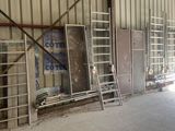 a room that has a lot of windows and ladders