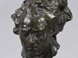 sculpture of a woman ' s head on a marble base