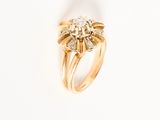 a close up of a gold ring with diamonds on a white background