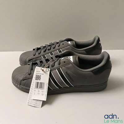 adidas superstar shoes with price tag on a white surface