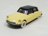 yellow toy car with black roof on white surface with white background
