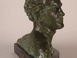 sculpture of a woman ' s head on a wooden base