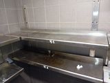 stainless steel counter top in a commercial kitchen with tile walls