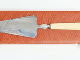 a red case with a trowet and a wooden handle on it