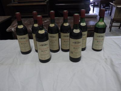 several bottles of wine are lined up on a table