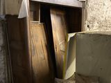 a wooden cabinet in the middle of a room that is being remodeled