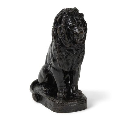 une statue représentant un lion assis par terre