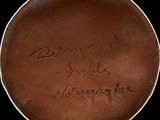 an image of a brown plate with writing on it