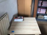 a wooden table with a book on it in a room