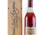 an old bottle of brandy in a wooden box next to a wooden box