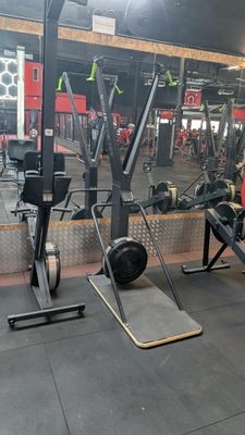 a man that is sitting on a bench in a gym