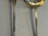 two spoons that are sitting on a table