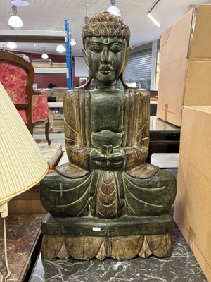 une statue de Bouddha assis sur une table