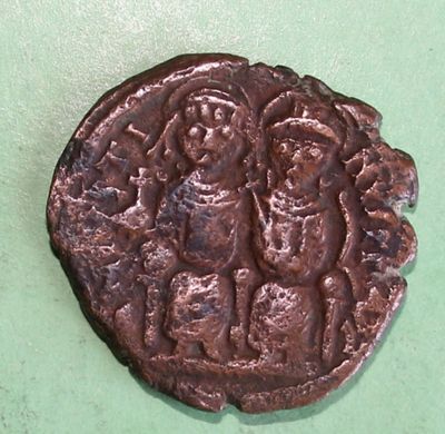 an old coin with a picture of a man and a woman on it