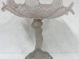 an image of a glass bowl with a woman holding a fish