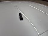a remote control sitting on the hood of a car