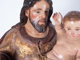 a statue of a man holding a baby in his lap