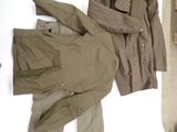 two jackets and pants laid out on a bed