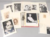 a lot of old photos of people on a table